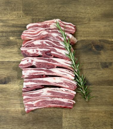 Lamb ribs on board with rosemary herb