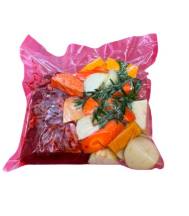 Beef and vegetables in a Cryovac bag ready to roast