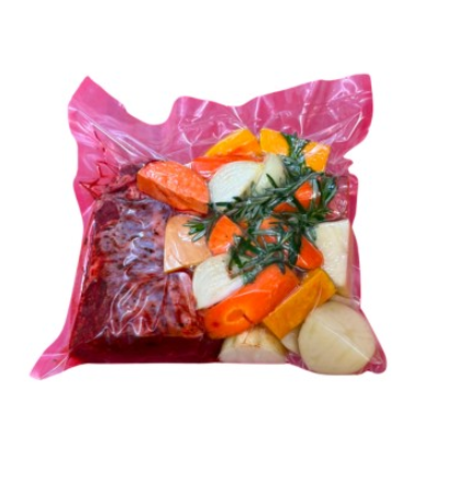 Beef and vegetables in a Cryovac bag ready to roast